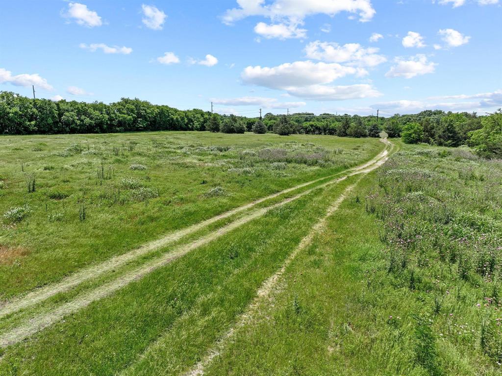 747 Vineyard Road Gunter, TX 75058 - Photo 20 of 32 a view of a green field with wooden fence
