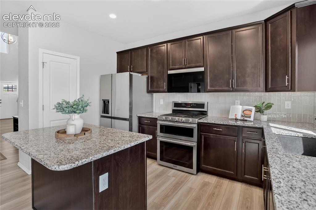 9734 Hidden Ranch Court Peyton, CO 80831 - Photo 9 of 29 Kitchen w/ stone counters