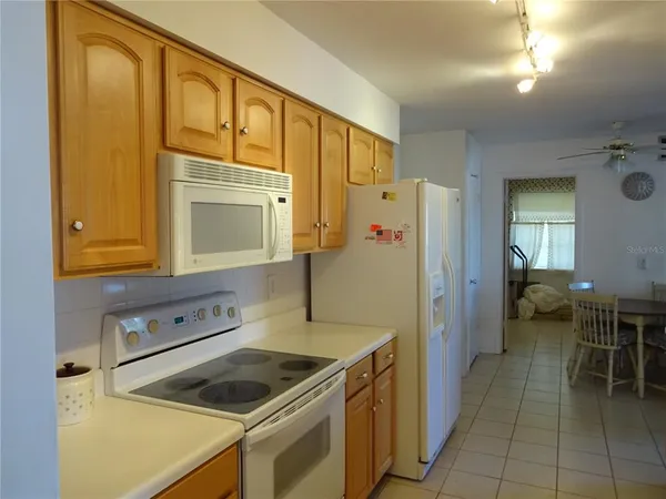 a kitchen that has a sink a stove and a refrigerator