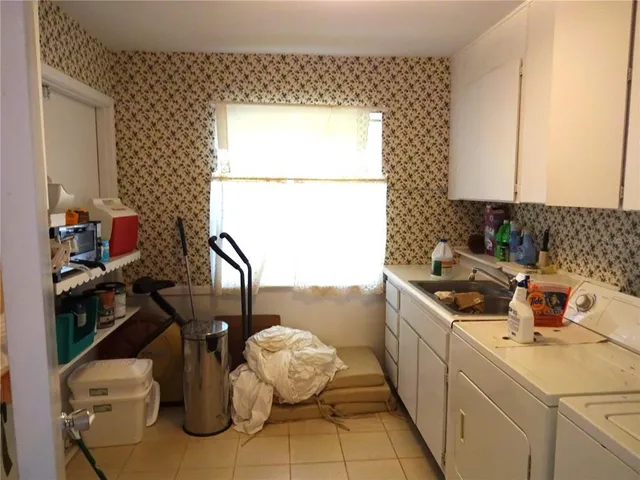 a kitchen with a sink and cabinets