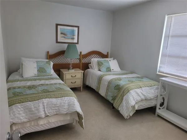 a bedroom with two beds and a window