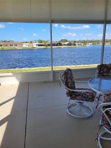 a view of a balcony with chair and table