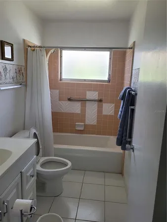 a bathroom with a toilet and a tub