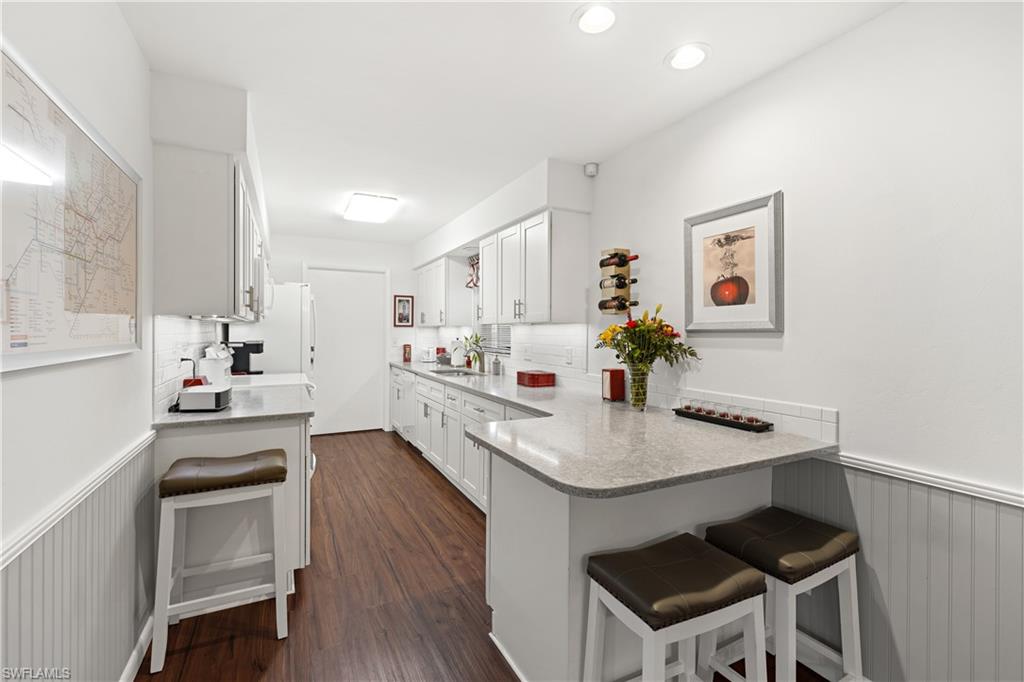 18517 Sebring Road Fort Myers, FL 33967 - Photo 11 of 32 a kitchen with a sink cabinets and wooden floor