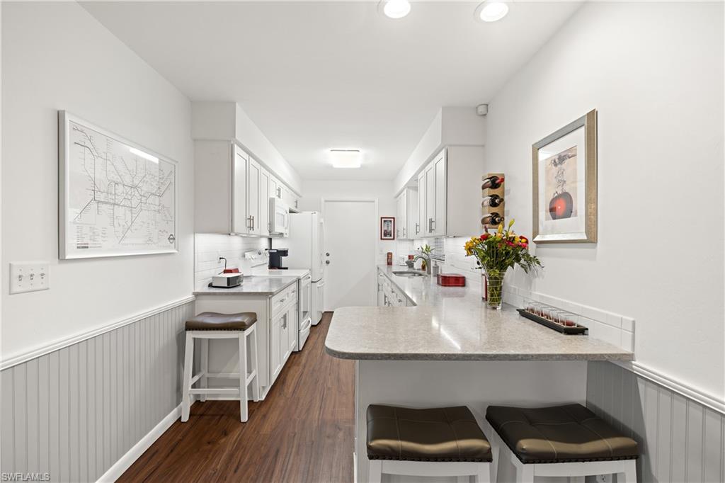 18517 Sebring Road Fort Myers, FL 33967 - Photo 12 of 32 a kitchen with sink cabinets and wooden floor