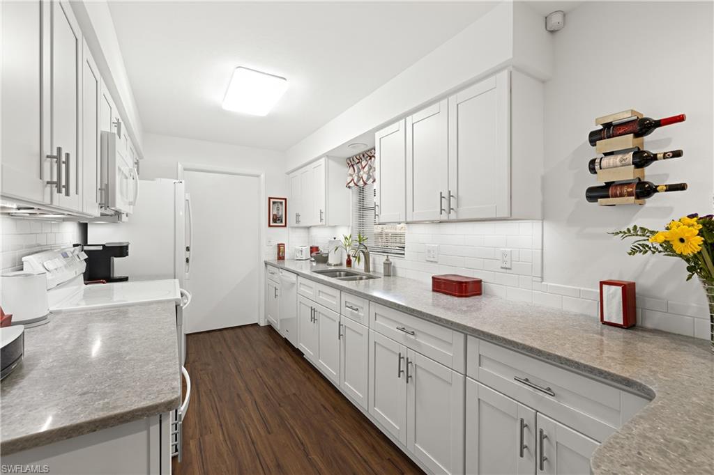 18517 Sebring Road Fort Myers, FL 33967 - Photo 13 of 32 a kitchen with cabinets a sink and wooden floor