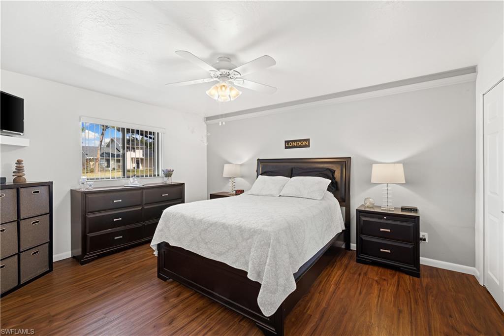 18517 Sebring Road Fort Myers, FL 33967 - Photo 16 of 32 a bedroom with a bed and a flat tv screen on dresser