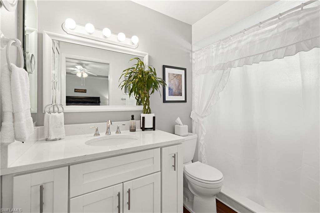 18517 Sebring Road Fort Myers, FL 33967 - Photo 18 of 32 a bathroom with a toilet sink and mirror