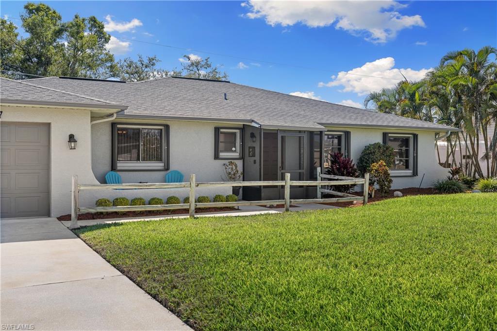 18517 Sebring Road Fort Myers, FL 33967 - Photo 3 of 32 a house view with a sitting space and garden