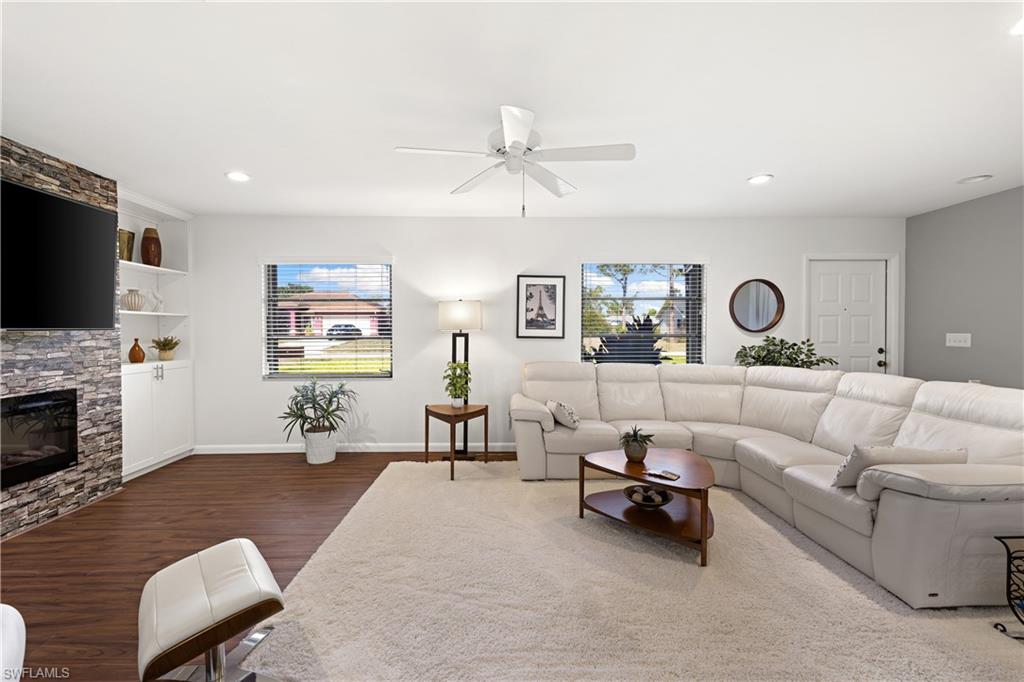 18517 Sebring Road Fort Myers, FL 33967 - Photo 6 of 32 a living room with furniture and a fireplace
