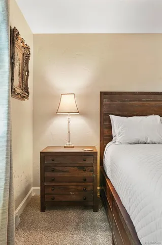 a bedroom with a bed and a lamp