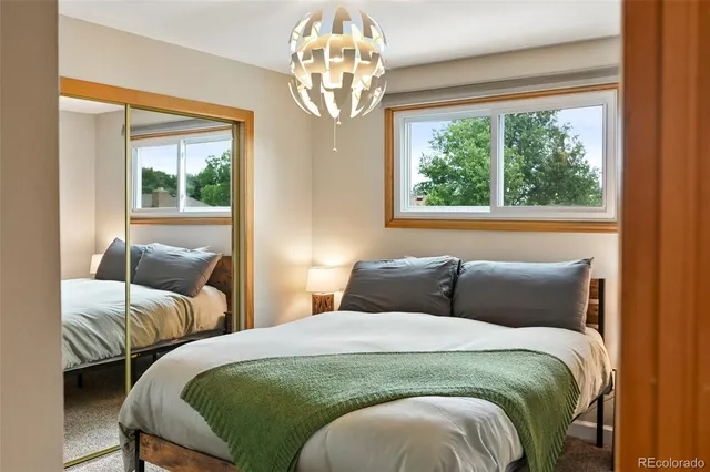 a bedroom with two beds and a large window