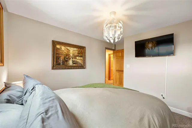 a bedroom with a large bed and a flat screen tv