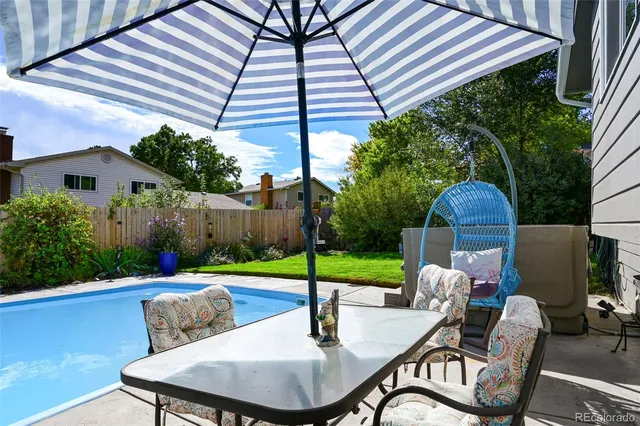 a backyard of a house with table and chairs