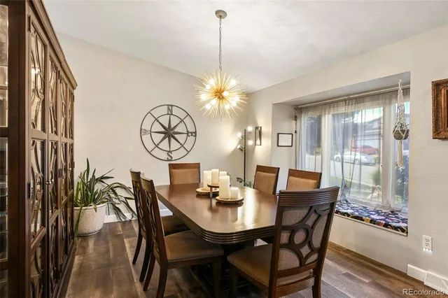 a view of a dining room with furniture window and wooden floor