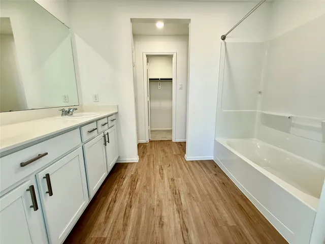 a bathroom with a sink a toilet a shower and a mirror