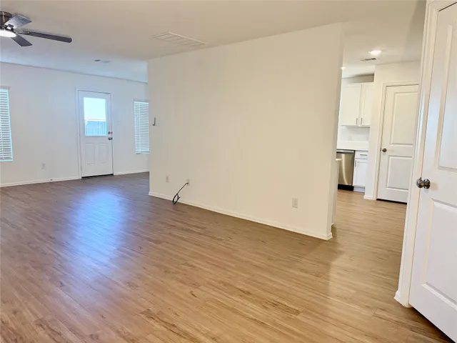 a view of kitchen with wooden floor and electronic appliances