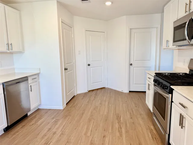 an empty room with wooden floor and a window