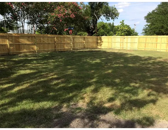 a view of yard with swimming pool and trees