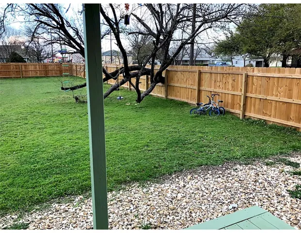 a backyard of a house with lots of green space