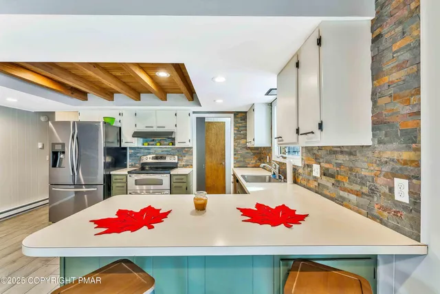a view of an empty room with wooden floor and closet