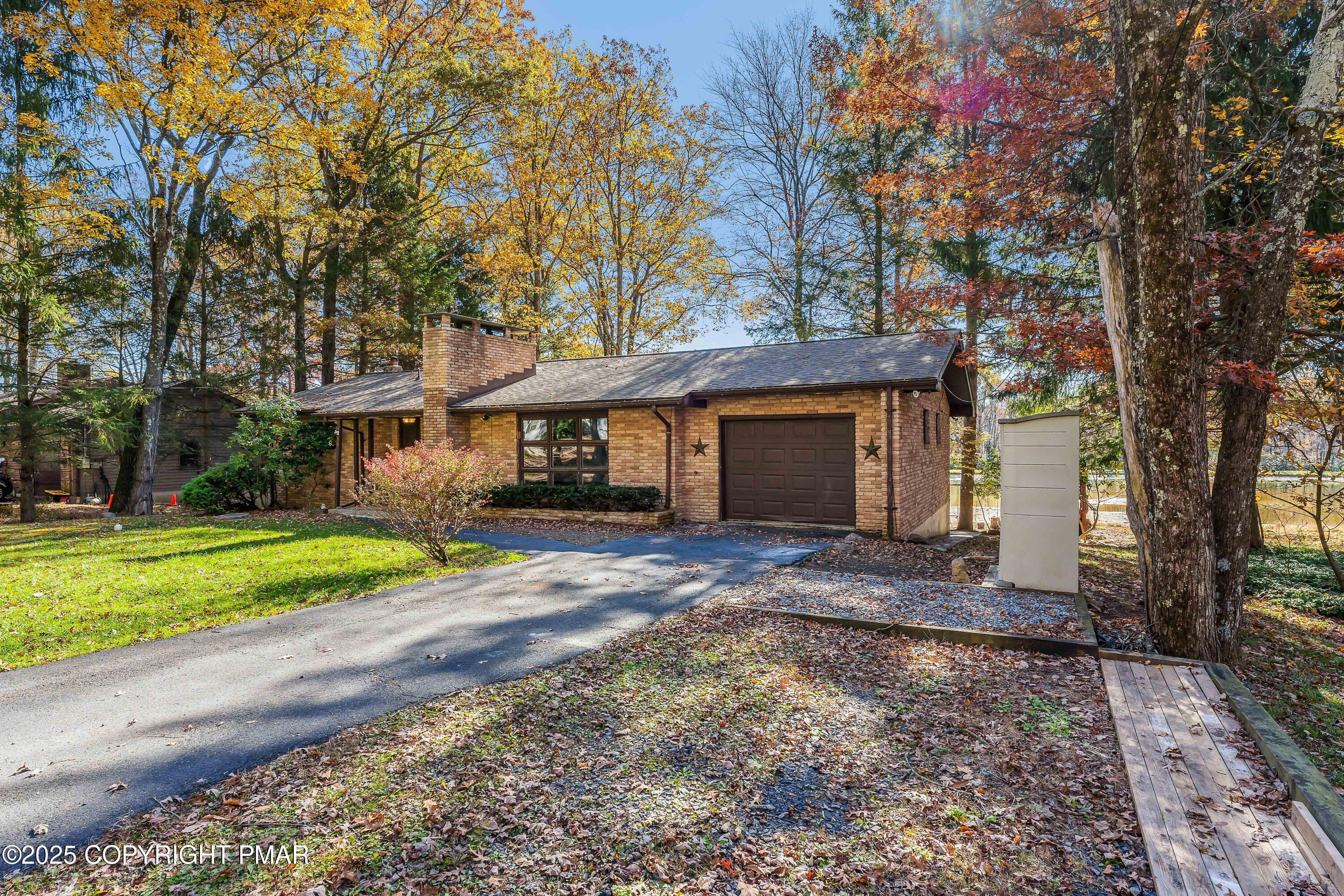 4193 Forest Drive Kunkletown, PA 18058 - Photo 3 of 33 a front view of a house with a yard and garage