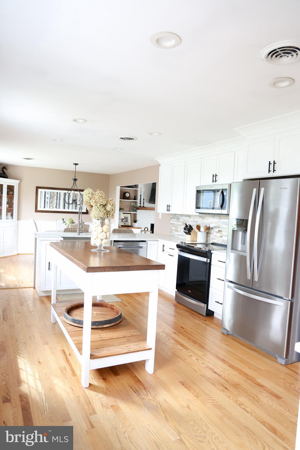 2353 Shuresville Road Darlington, MD 21034 - Photo 8 of 25 a kitchen with stainless steel appliances kitchen island granite countertop a refrigerator and a stove top oven