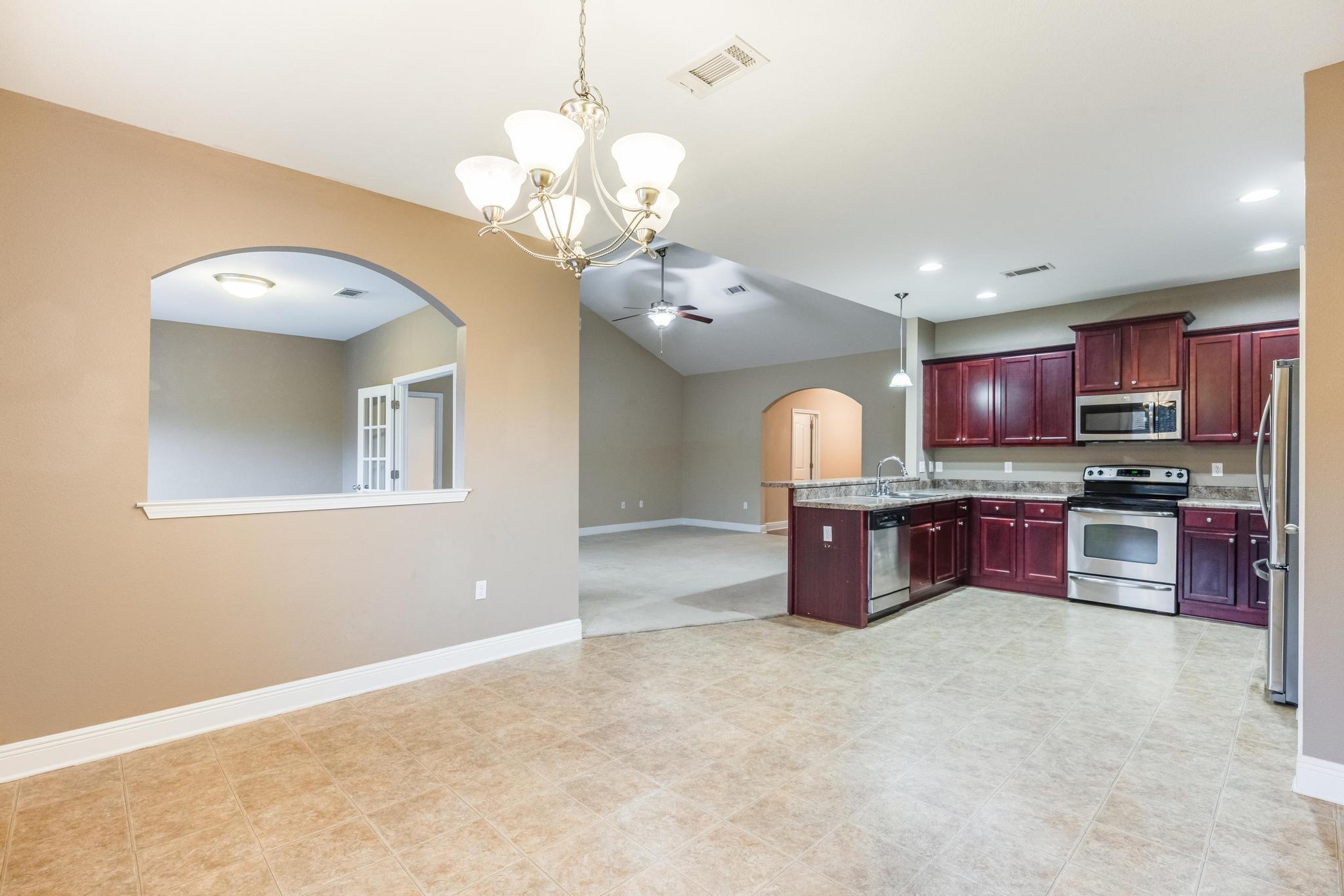 750 Lime Lane Crestview, FL 32536 - Photo 15 of 51 a large kitchen with stainless steel appliances granite countertop a stove oven and a refrigerator