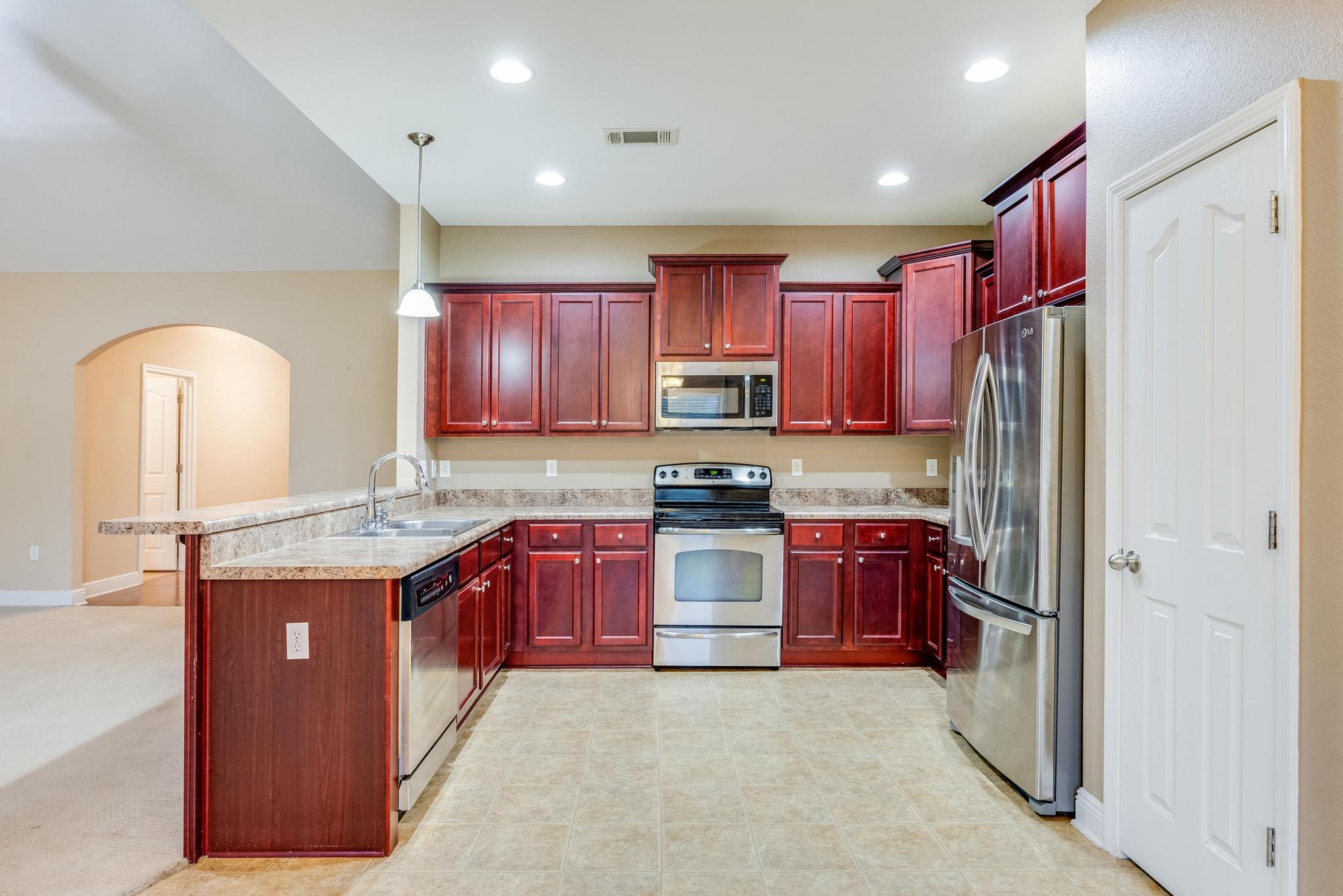 750 Lime Lane Crestview, FL 32536 - Photo 16 of 51 a large kitchen with stainless steel appliances granite countertop a refrigerator and a stove top oven