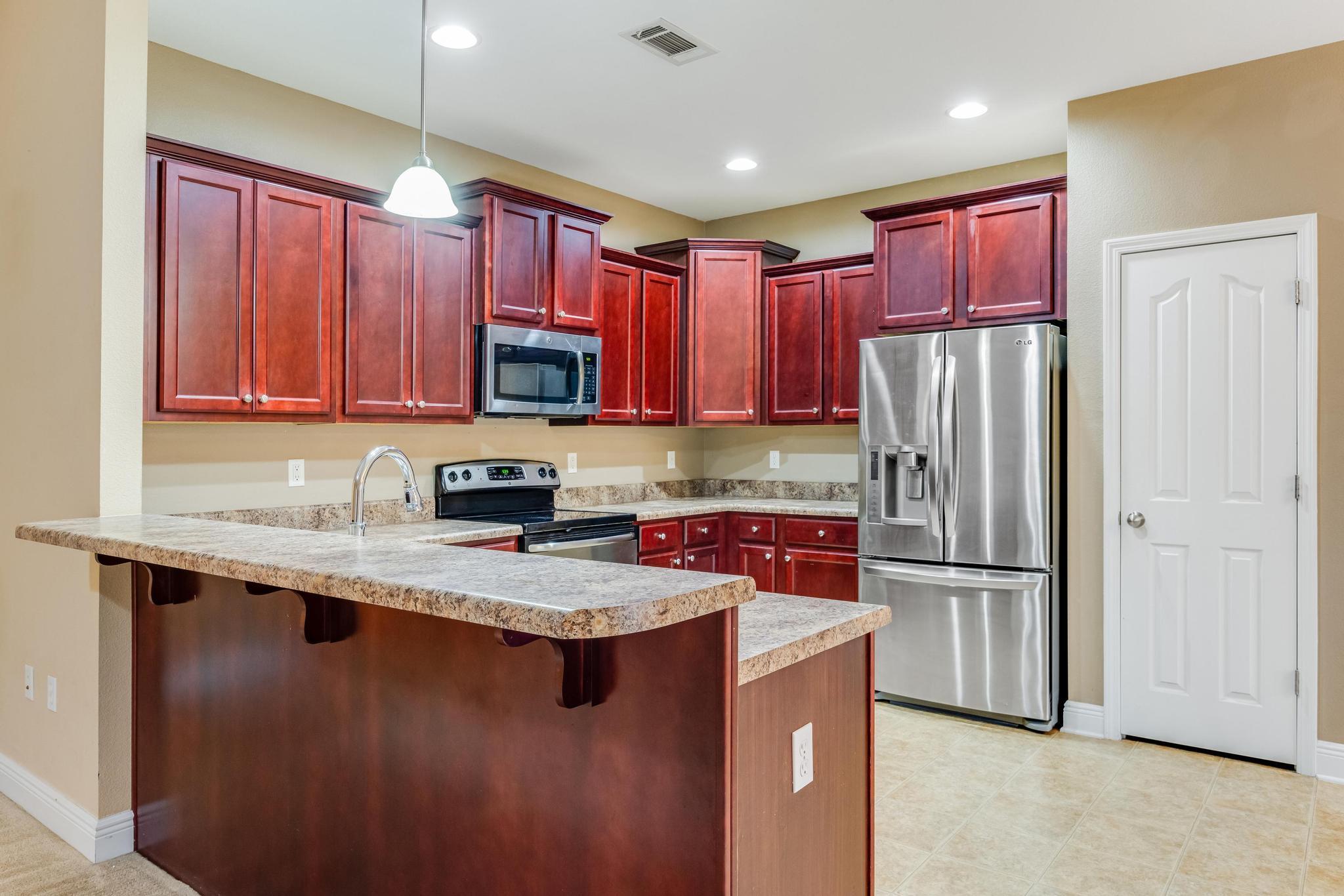 750 Lime Lane Crestview, FL 32536 - Photo 17 of 51 a kitchen with stainless steel appliances granite countertop a refrigerator stove a sink and a microwave