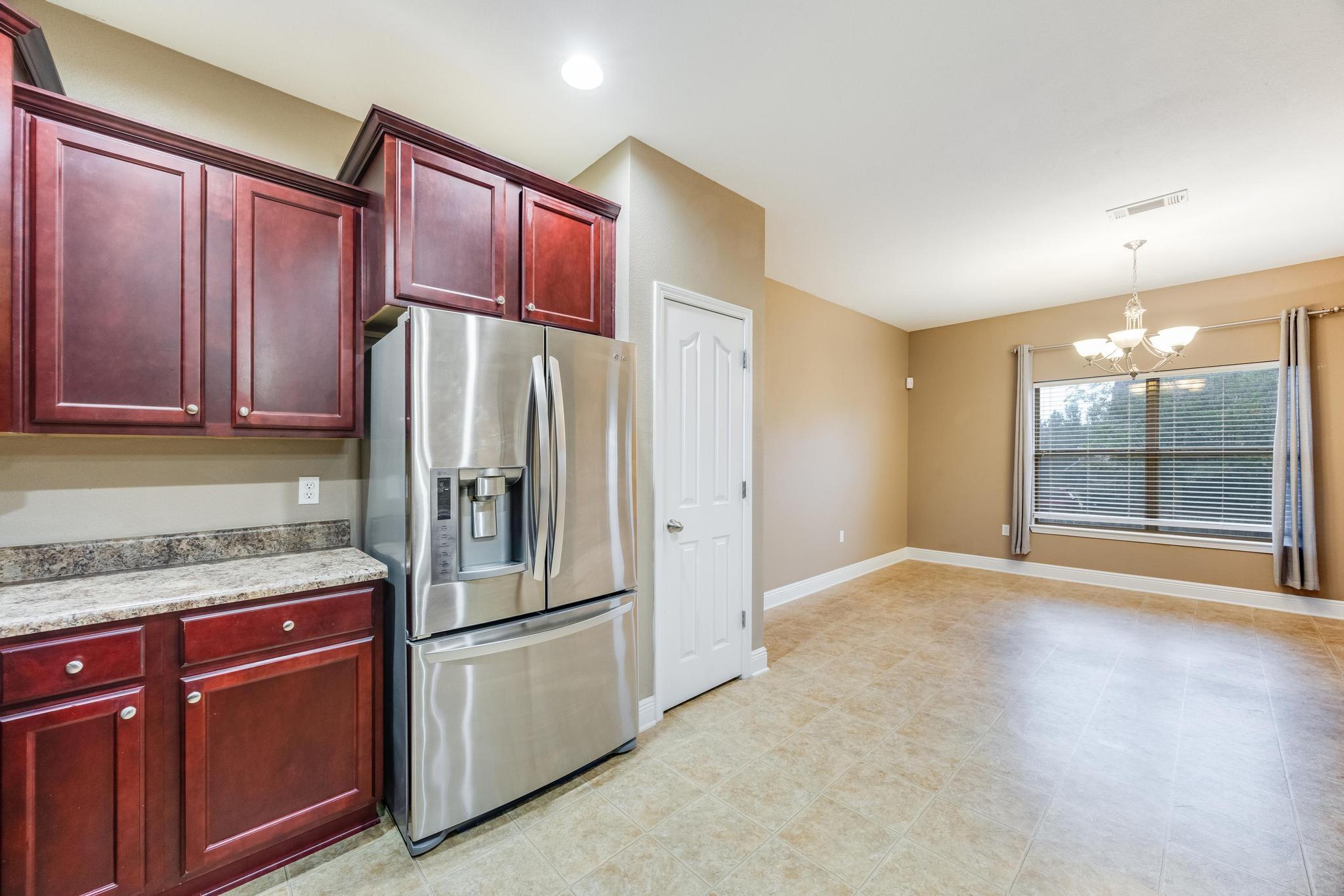 750 Lime Lane Crestview, FL 32536 - Photo 21 of 51 a kitchen with stainless steel appliances granite countertop a refrigerator stove and cabinets