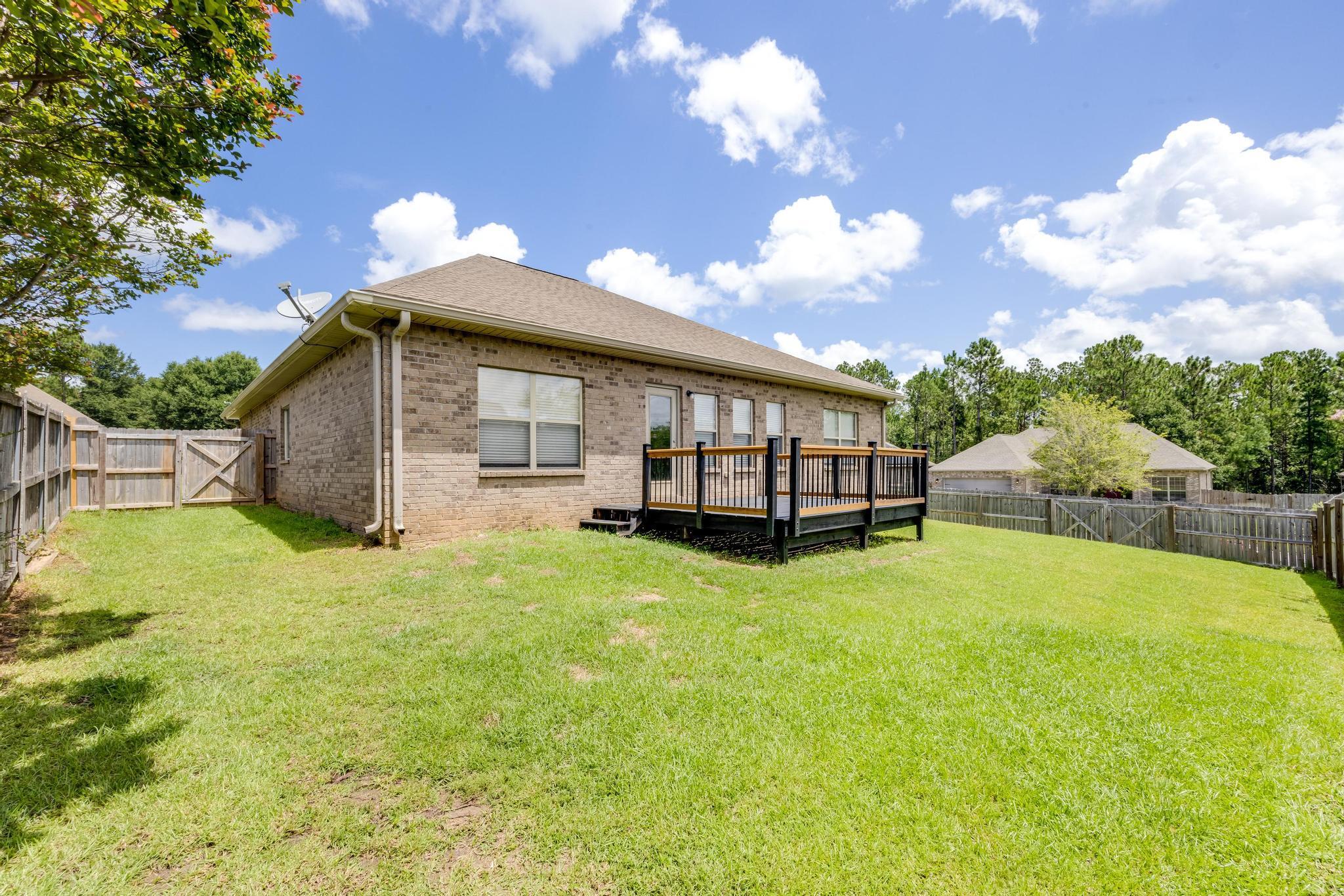 750 Lime Lane Crestview, FL 32536 - Photo 41 of 51 a yellow house sitting in middle of the middle of a yard