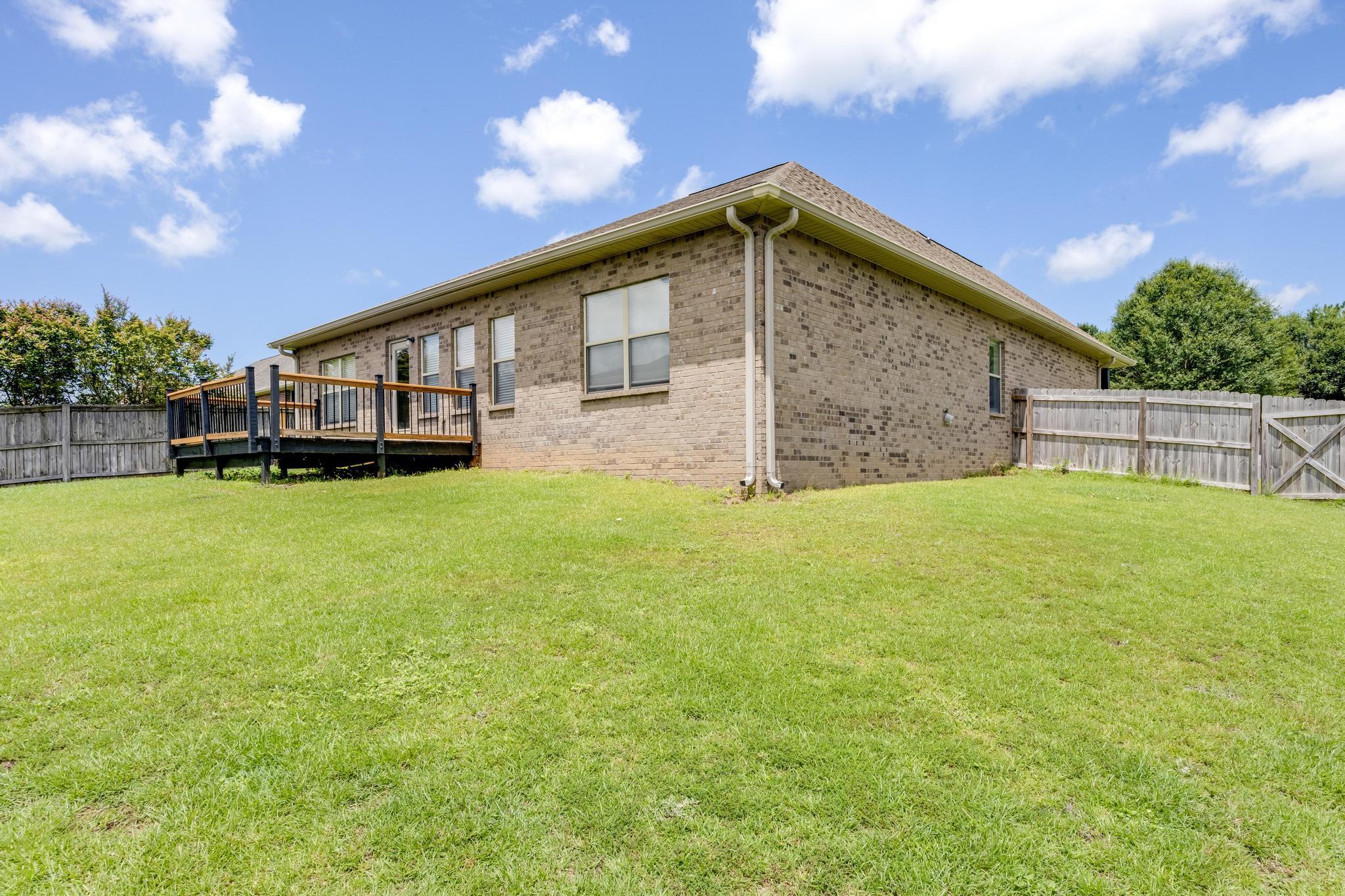 750 Lime Lane Crestview, FL 32536 - Photo 50 of 51 a backyard of a house with large trees and table and chairs