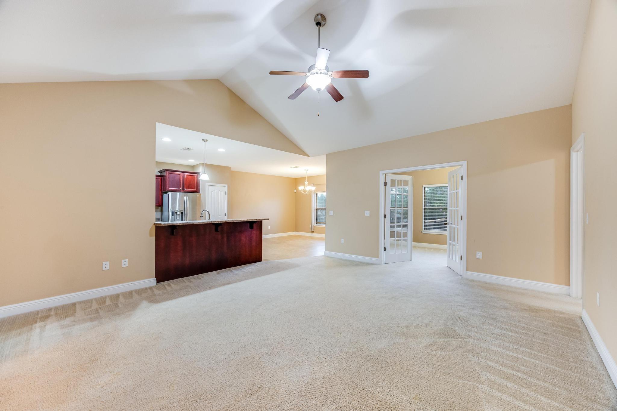 750 Lime Lane Crestview, FL 32536 - Photo 6 of 51 a view of an empty room with window and chandelier fan