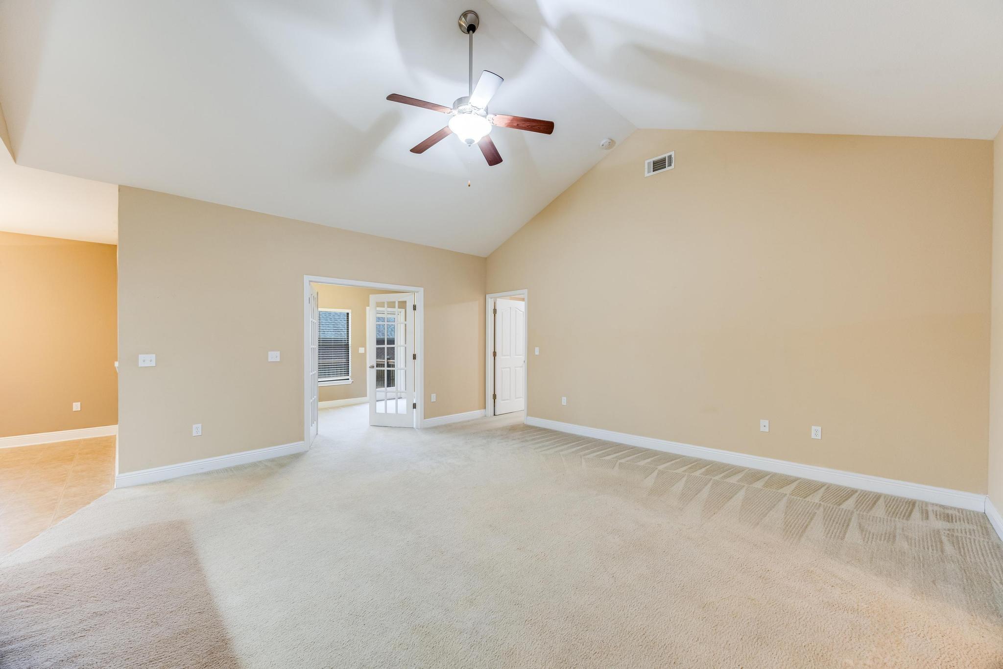 750 Lime Lane Crestview, FL 32536 - Photo 7 of 51 an empty room with chandelier fan and windows
