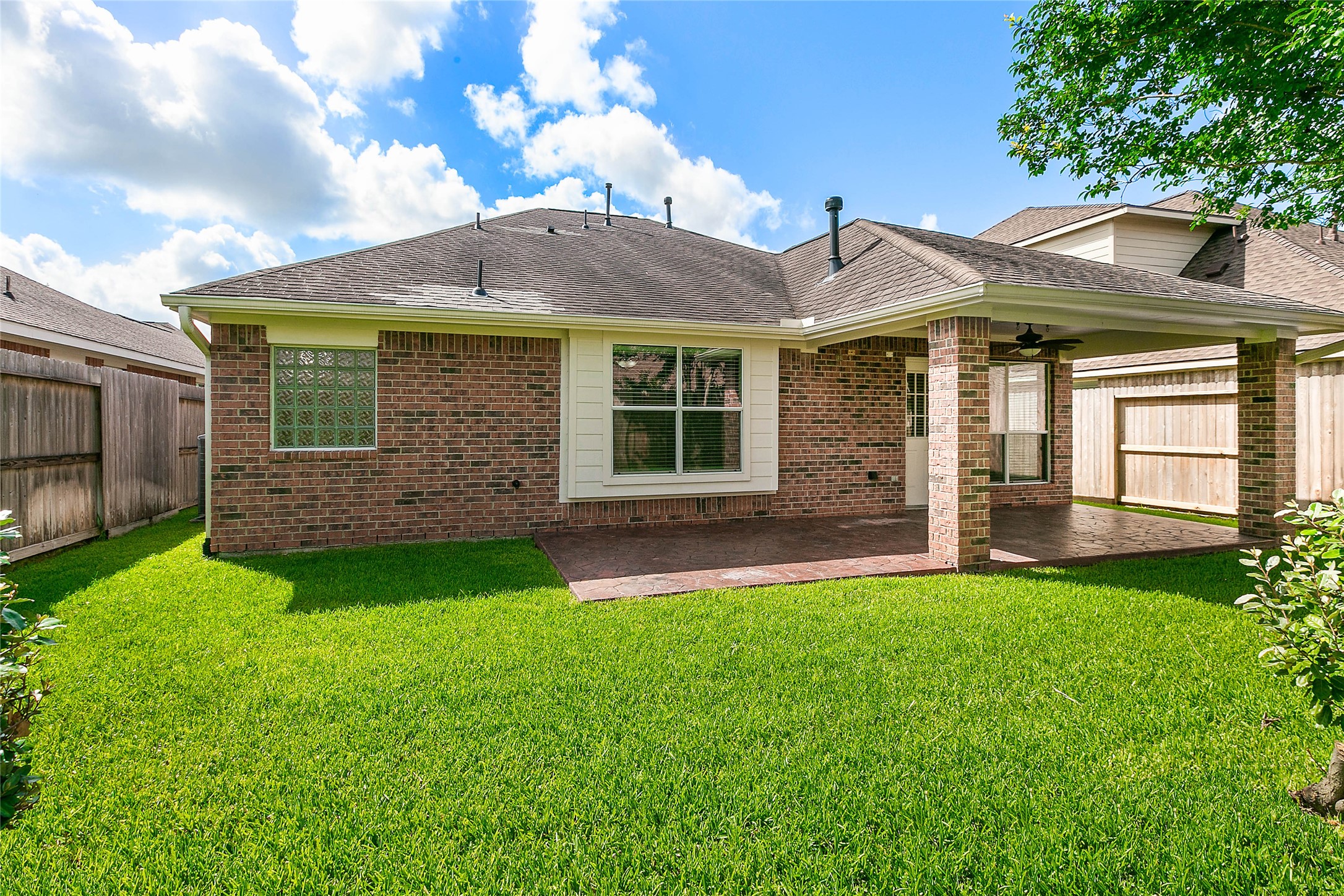 30411 Deleon Fields Drive Spring, TX 77386 - Photo 22 of 24 Your private outdoor oasis awaits with a spacious covered patio and a beautiful lawn.