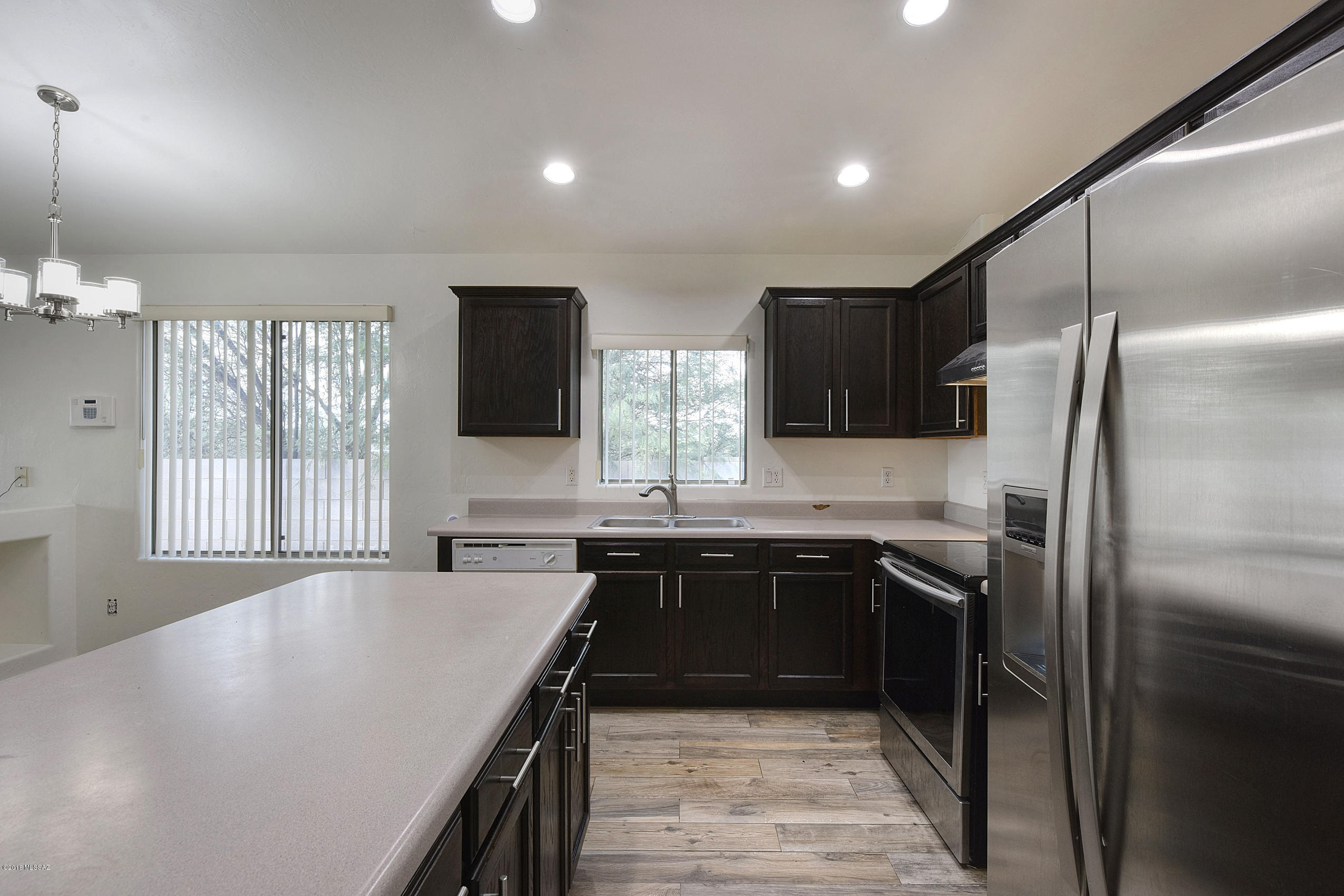 4328 South Valley Road Tucson, AZ 85714 - Photo 6 of 29 a kitchen with stainless steel appliances granite countertop a sink a stove and refrigerator