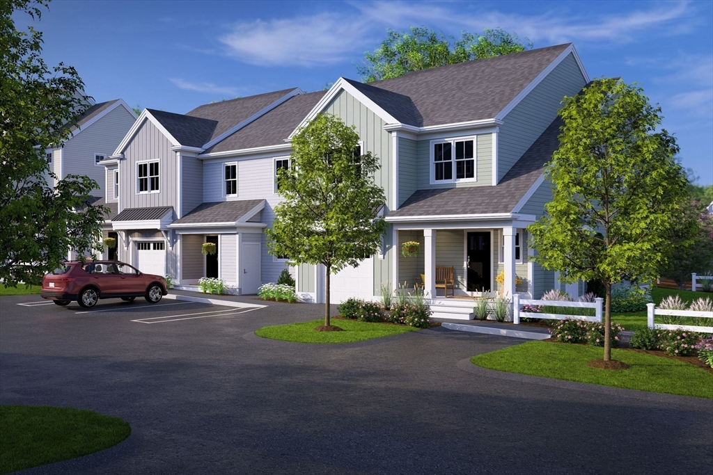 7 Oxbow Road, Unit 51 Raynham, MA 02767 - Photo 18 of 40 a front view of a house with a garden and trees