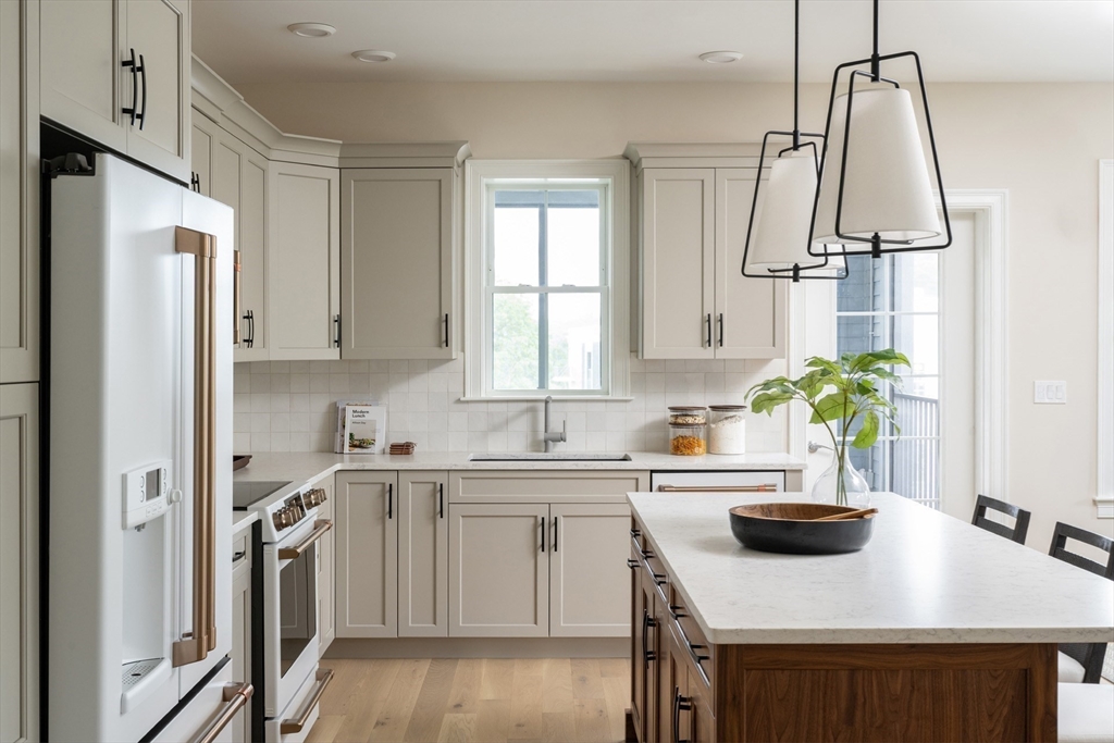 7 Oxbow Road, Unit 51 Raynham, MA 02767 - Photo 8 of 40 a kitchen with white cabinets and stainless steel appliances