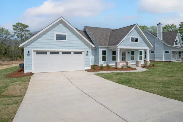 a view of a house with backyard porch and sitting area