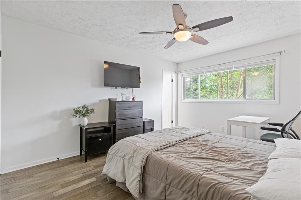 3236 Henderson Mill Road, Unit 1 Chamblee, GA 30341 - Photo 19 of 23 a bedroom with a bed and a flat screen tv