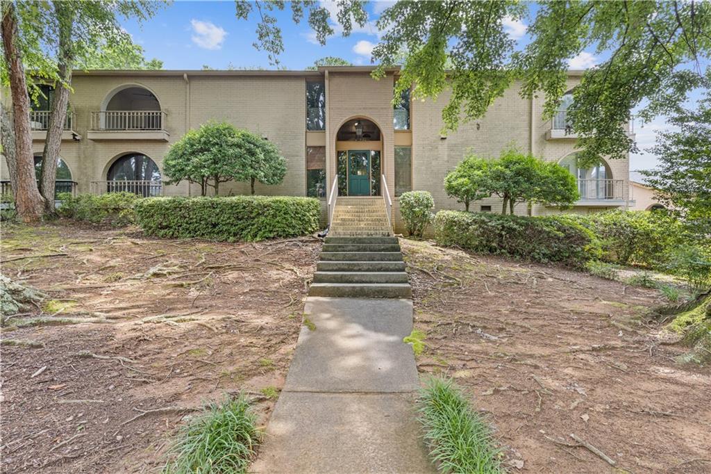3236 Henderson Mill Road, Unit 1 Chamblee, GA 30341 - Photo 2 of 23 a front view of a house with garden
