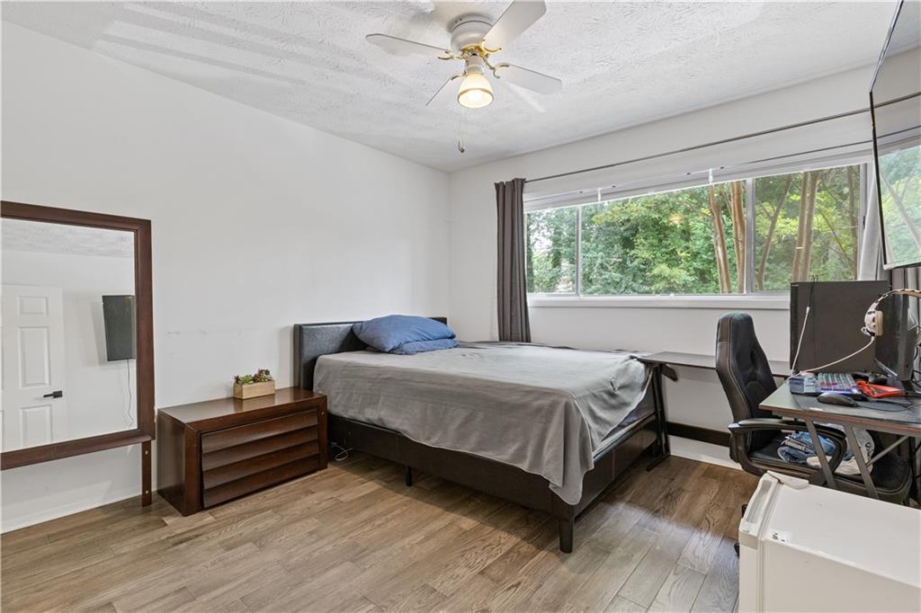 3236 Henderson Mill Road, Unit 1 Chamblee, GA 30341 - Photo 21 of 23 a bedroom with a bed and a chandelier