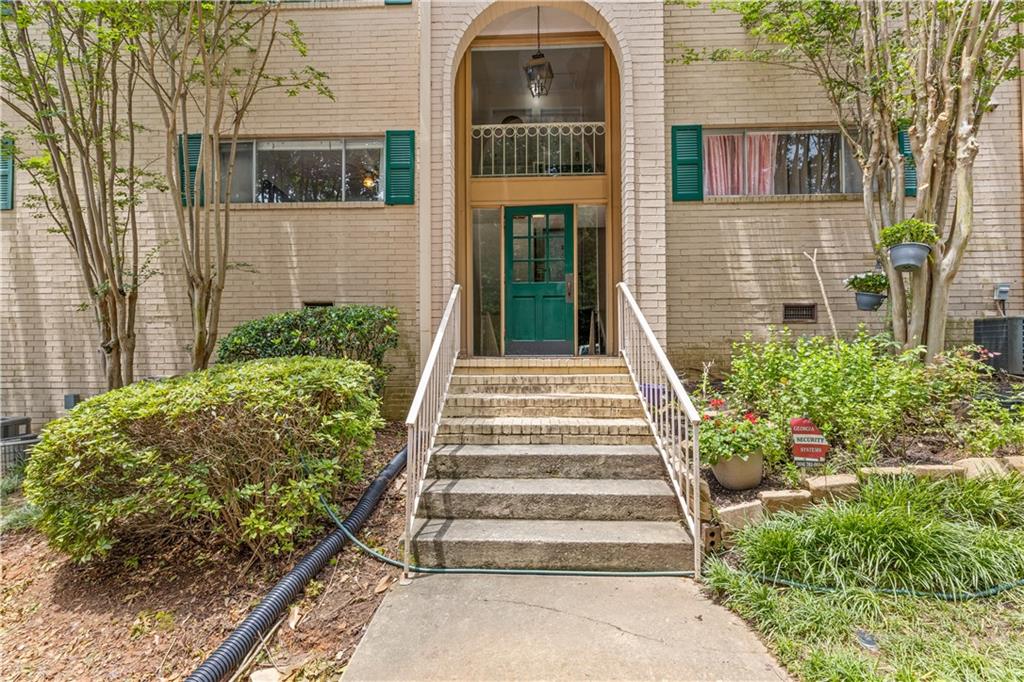 3236 Henderson Mill Road, Unit 1 Chamblee, GA 30341 - Photo 4 of 23 a front view of a house with a garden
