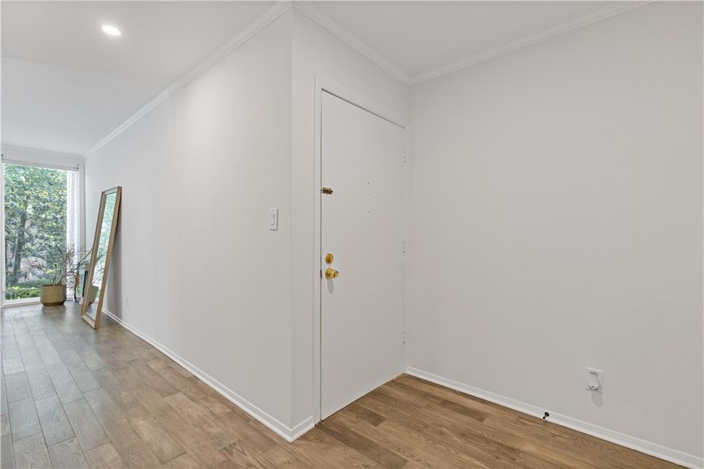 3236 Henderson Mill Road, Unit 1 Chamblee, GA 30341 - Photo 7 of 23 wooden floor in an empty room with a window