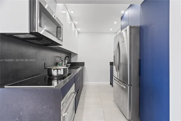 a kitchen with stainless steel appliances granite countertop a refrigerator and a sink
