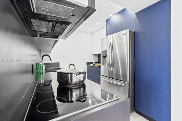 a kitchen with a refrigerator and a sink