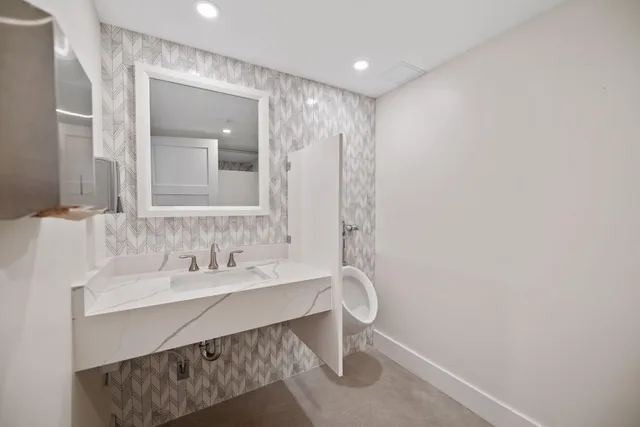 a bathroom with a sink and a mirror