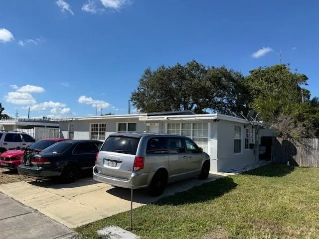 a view of a car parked in front of a house