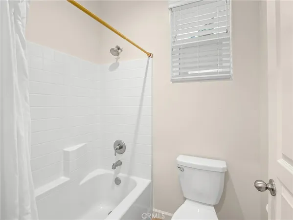 a bathroom with a toilet and a bathtub